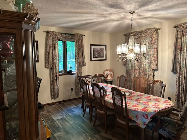 dining room featuring a textured ceiling, baseboards, dark wood-style flooring, and a chandelier