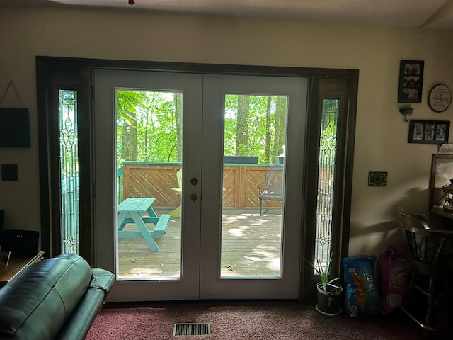 doorway to outside featuring french doors and visible vents