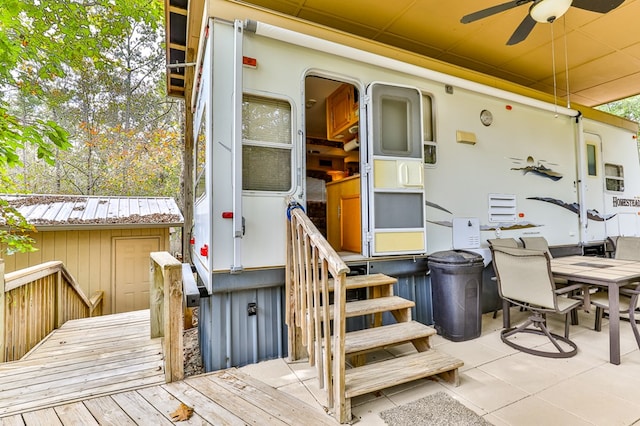 view of exterior entry with a patio area and ceiling fan