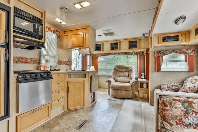 kitchen with stainless steel range and light brown cabinets