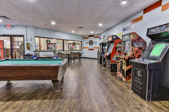 playroom featuring dark wood-type flooring, a paneled ceiling, and billiards