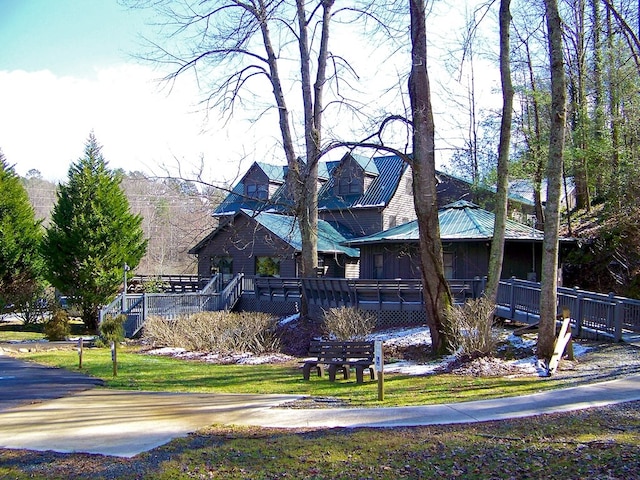 view of side of home featuring a yard and a deck