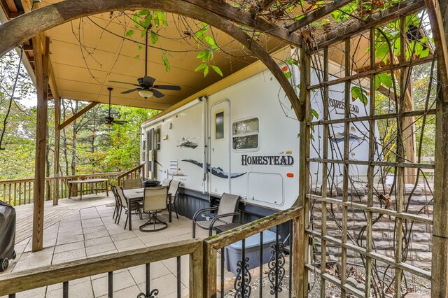 wooden deck featuring a patio area and ceiling fan