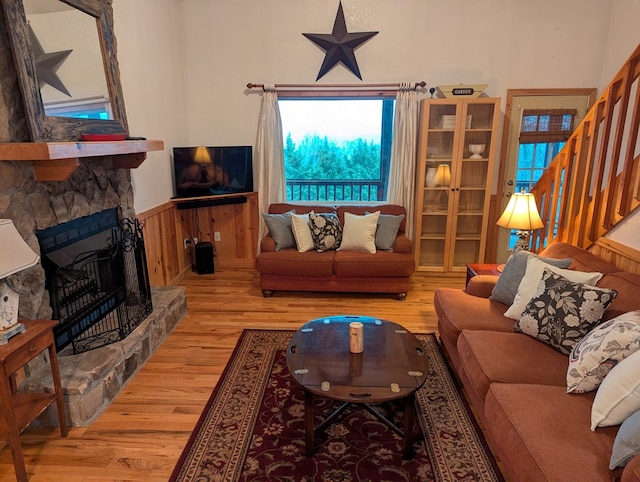 living room featuring a fireplace and light wood-type flooring