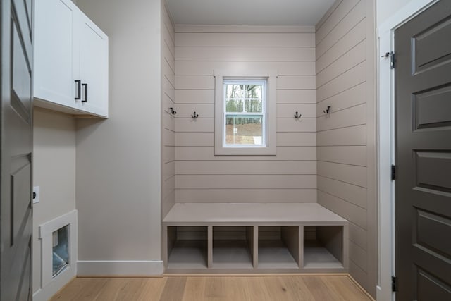 mudroom with baseboards and light wood-style flooring