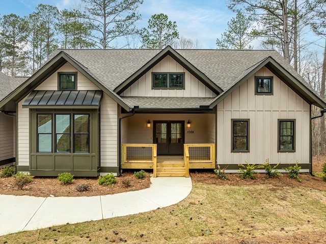 view of front of home with french doors, board and batten siding, a shingled roof, and a porch