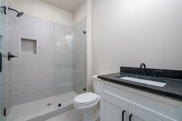 full bathroom featuring vanity, a stall shower, and toilet