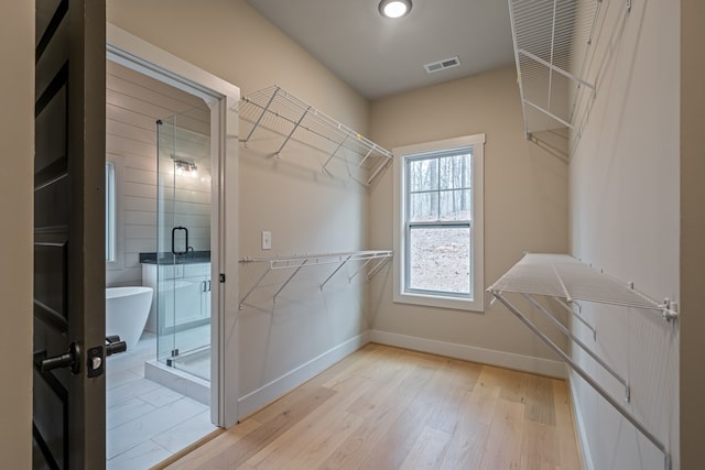 spacious closet with light wood finished floors and visible vents
