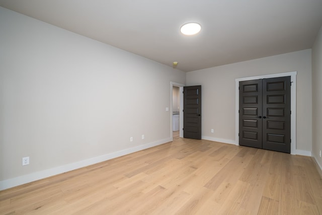 unfurnished bedroom with baseboards and light wood finished floors