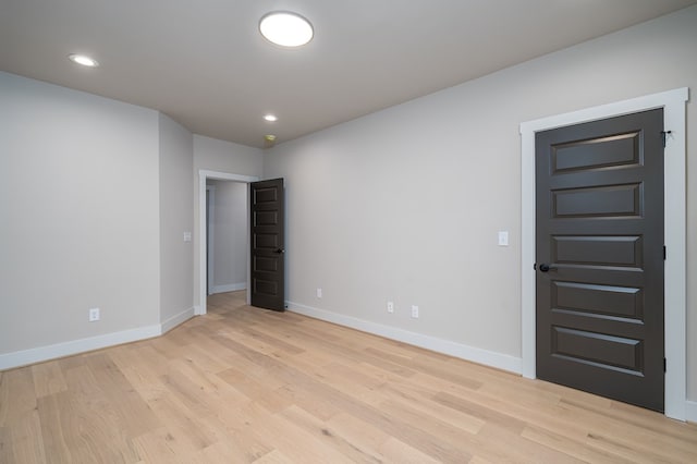 spare room with recessed lighting, baseboards, and light wood-style floors