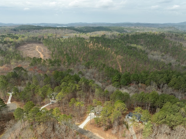 drone / aerial view featuring a wooded view