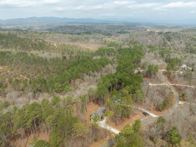 drone / aerial view featuring a mountain view and a wooded view