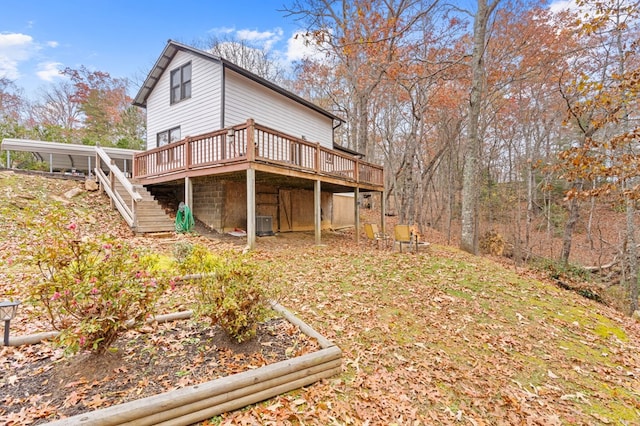 back of property featuring a wooden deck