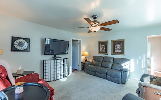 carpeted living room with ceiling fan