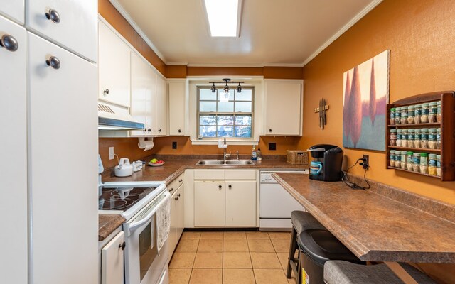 kitchen featuring custom range hood, sink, white appliances, and white cabinetry