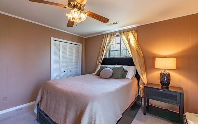 bedroom with carpet floors, a closet, ceiling fan, and crown molding