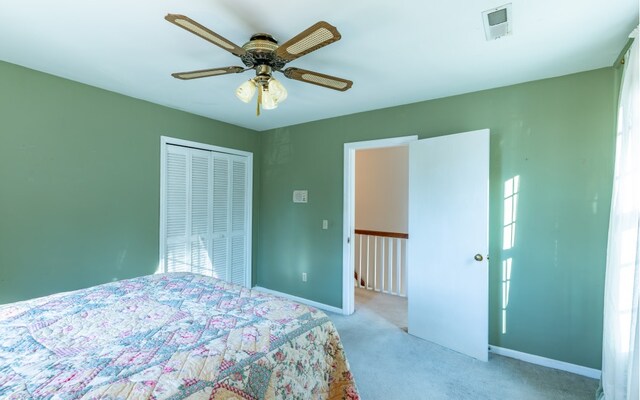 carpeted bedroom with a closet and ceiling fan