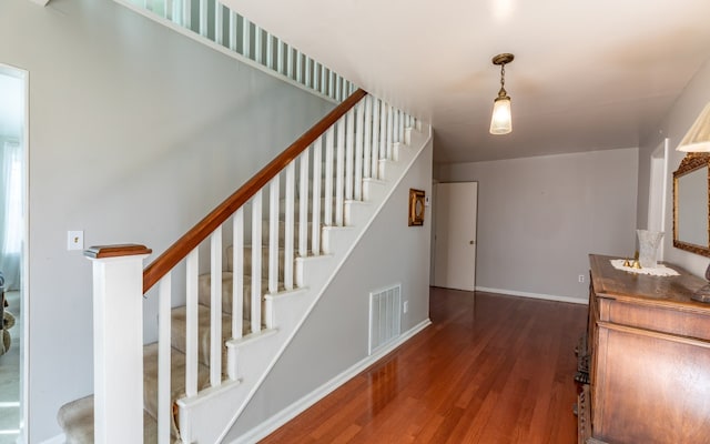 stairway featuring dark hardwood / wood-style flooring