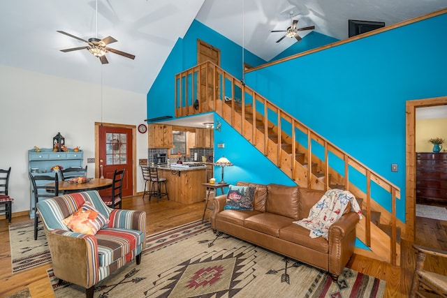 living room featuring high vaulted ceiling, wood-type flooring, and ceiling fan