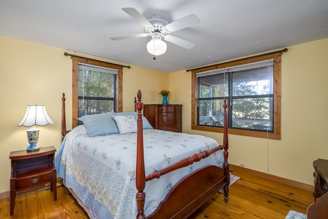 bedroom with ceiling fan and wood-type flooring