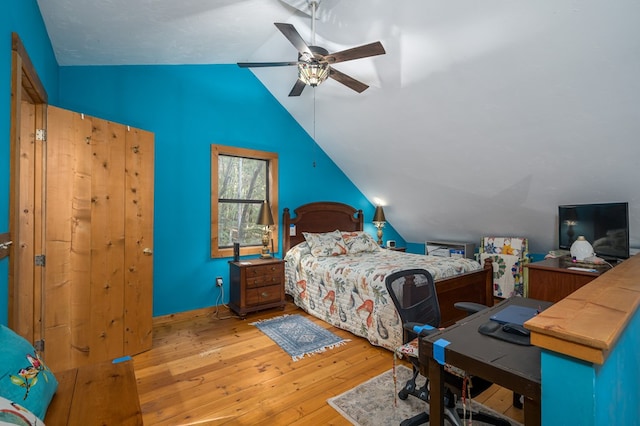 bedroom featuring light hardwood / wood-style flooring, ceiling fan, and lofted ceiling