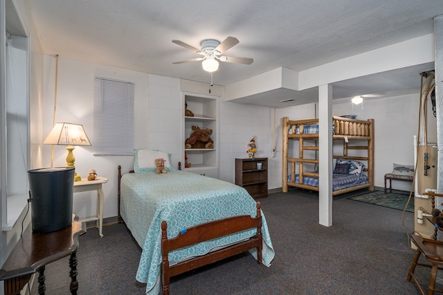 carpeted bedroom featuring ceiling fan and a textured ceiling