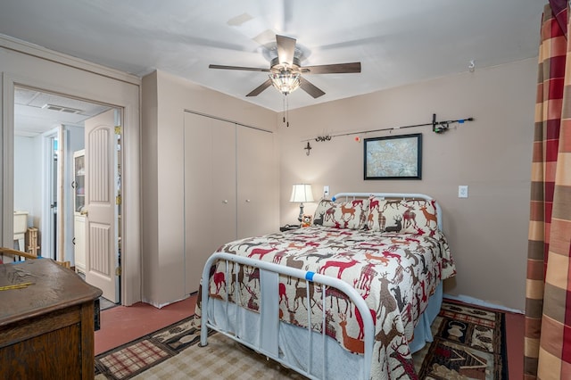 carpeted bedroom with a closet and ceiling fan