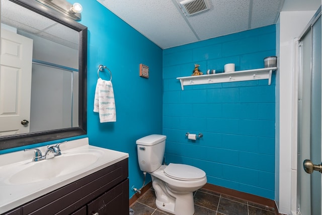 bathroom with vanity, toilet, a shower, and tile patterned flooring