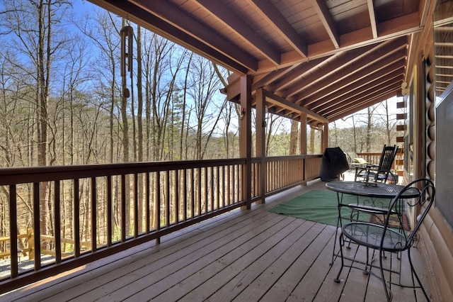 wooden terrace with a wooded view