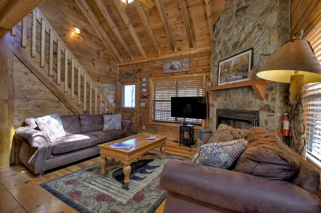 living area featuring stairway, wood walls, wooden ceiling, and hardwood / wood-style flooring