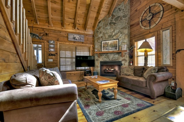 living area featuring hardwood / wood-style floors, wooden ceiling, wooden walls, and beam ceiling