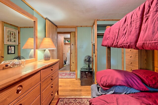 bedroom featuring a textured ceiling and light hardwood / wood-style floors