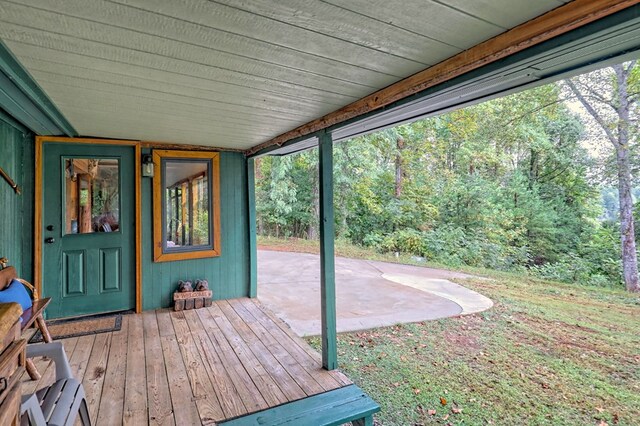 wooden terrace featuring a patio area