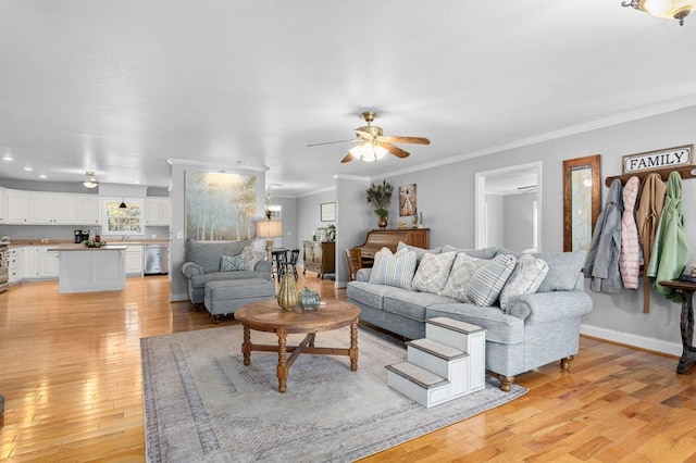 living room with ceiling fan, light hardwood / wood-style flooring, and crown molding