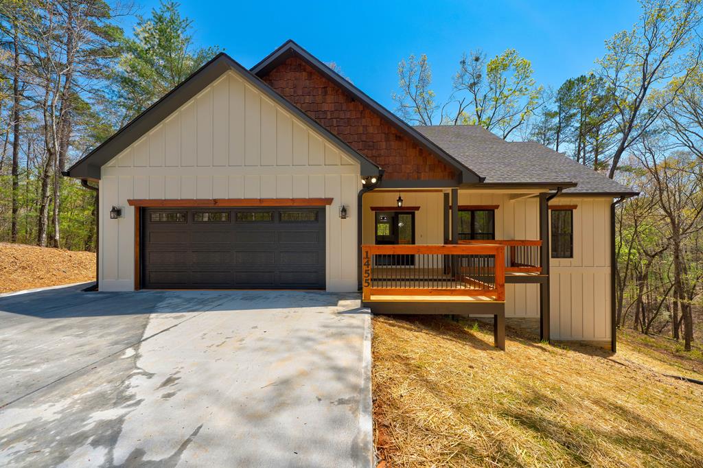 1455 Hap Holt Rd, Ellijay, GA 30540 - view of front of property with concrete driveway, an attached garage, roof with shingles, and board and batten siding