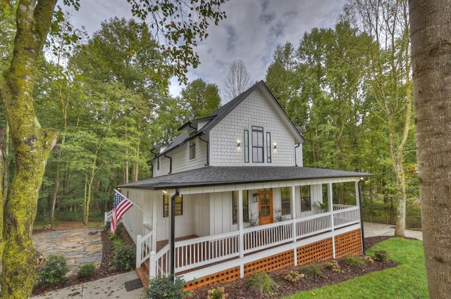 view of front of house with covered porch and roof with shingles