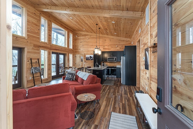 living room with wood walls, dark wood-type flooring, wooden ceiling, beam ceiling, and french doors