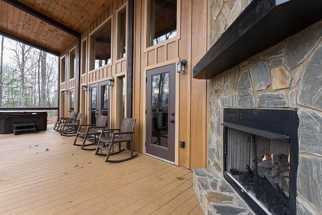 wooden deck with a hot tub and french doors