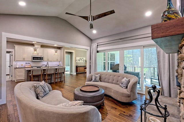 living room with lofted ceiling, ceiling fan, and dark hardwood / wood-style floors