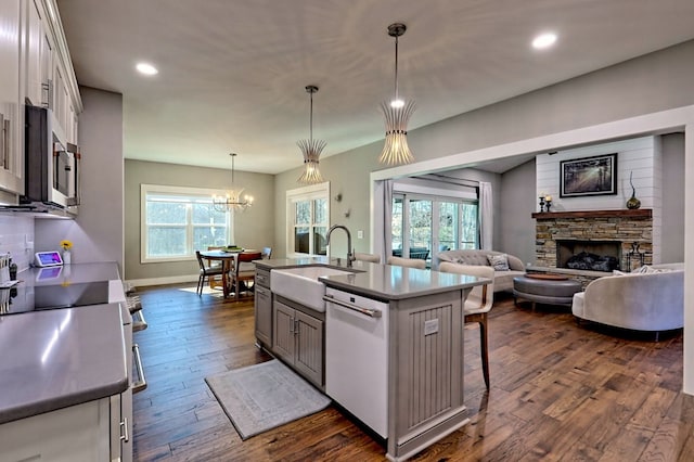 kitchen with white cabinetry, sink, pendant lighting, a center island with sink, and appliances with stainless steel finishes