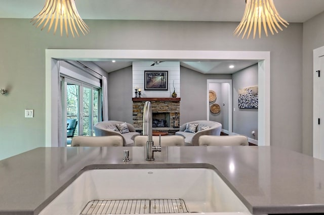 kitchen featuring a fireplace, sink, and a chandelier