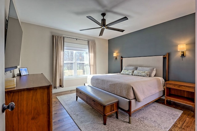 bedroom featuring ceiling fan and dark wood-type flooring