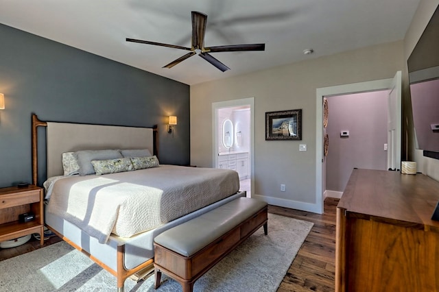 bedroom with ensuite bath, ceiling fan, and dark hardwood / wood-style floors