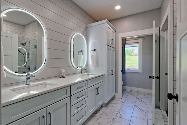 bathroom with vanity, toilet, and wood walls