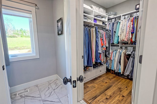 walk in closet featuring light hardwood / wood-style floors