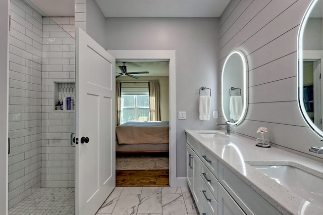 bathroom with vanity and tiled shower