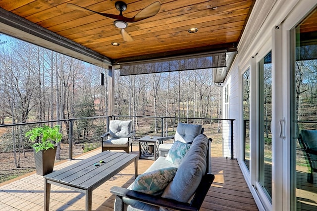 sunroom featuring ceiling fan, a wealth of natural light, and wood ceiling