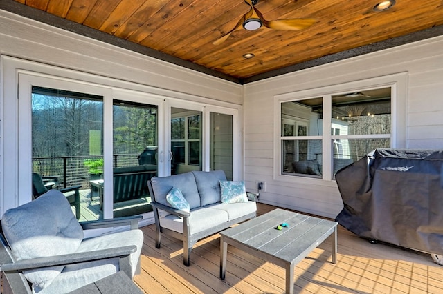 deck featuring ceiling fan and an outdoor living space