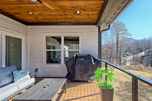 view of patio / terrace featuring area for grilling, ceiling fan, and a balcony