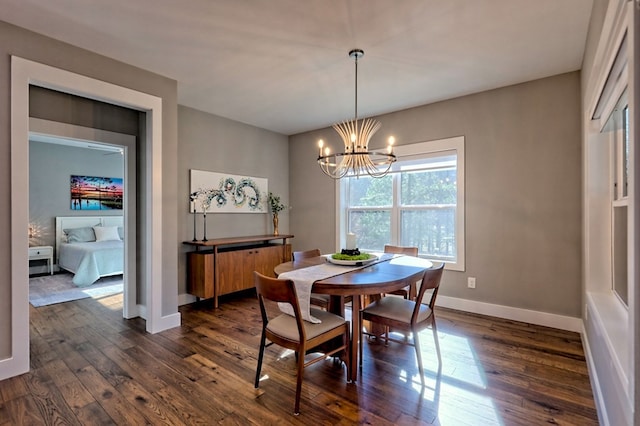 dining area with dark hardwood / wood-style floors and a chandelier